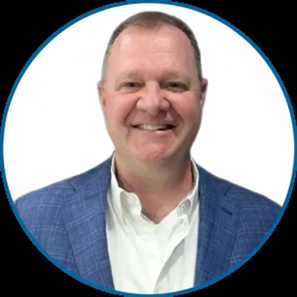 Headshot of Dr. Terry Sheridan smiling, wearing a blue blazer and white shirt.